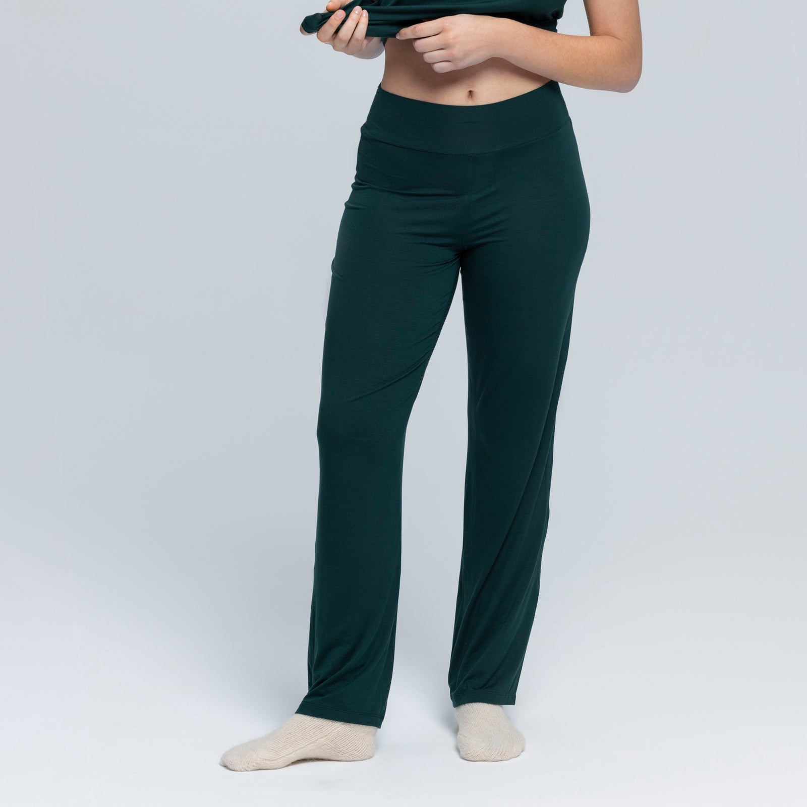 Model wearing dark green casual matching outfit.